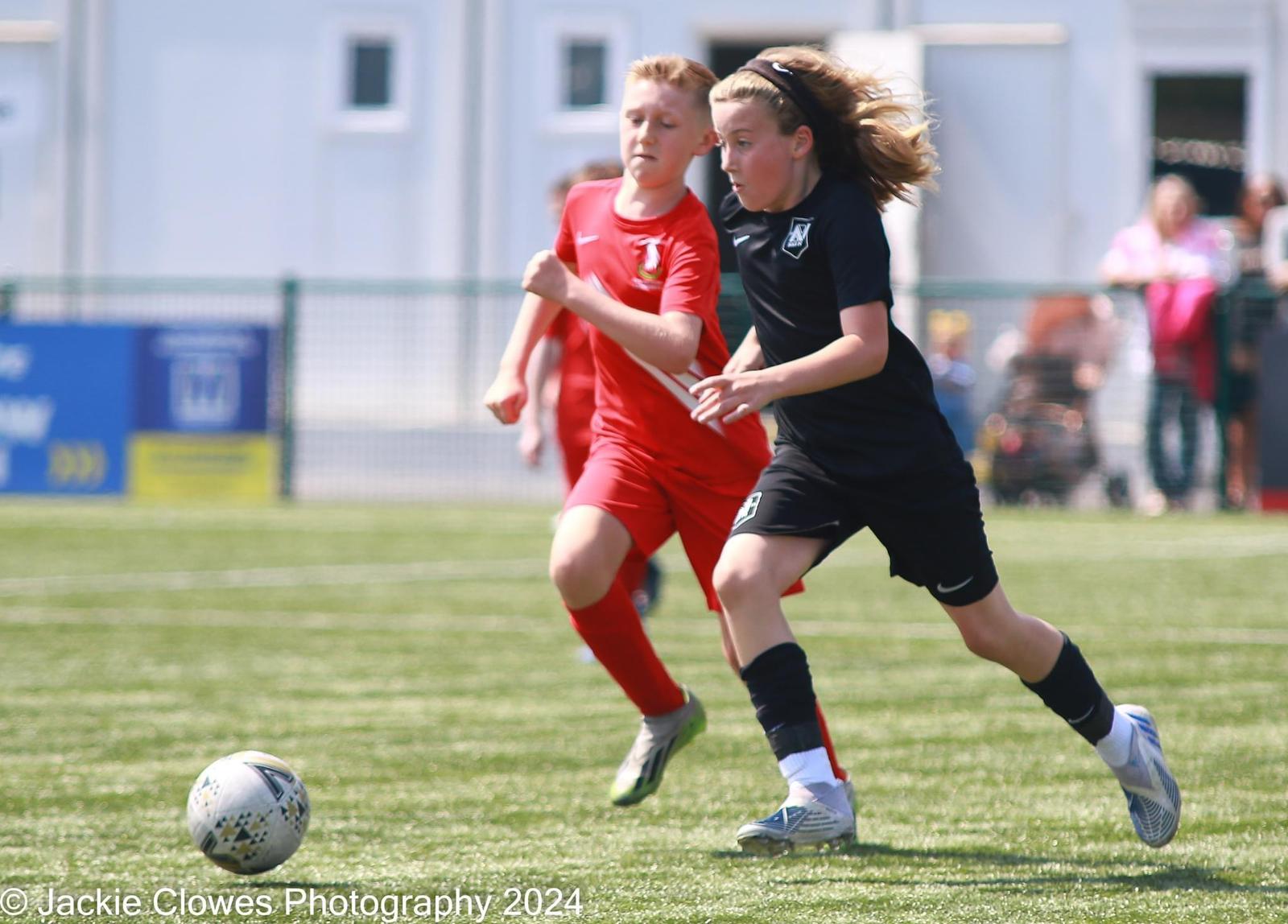 NAR player running towards the ball during a youth football match