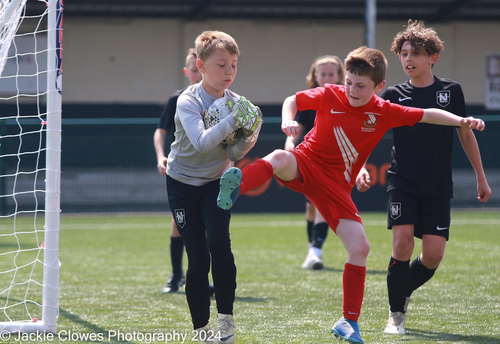 NAR goalkeeper holding the ball during a youth football match